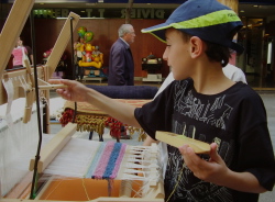 boys having a go at weaving on a Louet loom from Anna Champeney Textile Studio